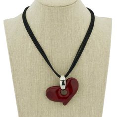 Step out in style and show off your Italian glamour with this stunning Murano Glass Heart Pendant Necklace. The beautiful heart in the rich red color was handmade in a family-owned glass-making workshop in Murano, Italy. The pendant is accentuated with a contemorary metal bail and suspended from a simple silky black cord, which provides the ideal complement to the heart without detracting from its beauty. Wear it with your favorite dress for a night out or with a casual outfit for everyday chic Red Pendant Silver Necklace, Luxury Red Heart Charm Necklace, Puff Heart Glass Necklace, Vintage Glass Heart Necklace, Red Glass Jewelry, Glass Heart Necklace, Italian Glamour, Italian Chic, Murano Glass Necklaces