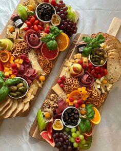 two wooden trays filled with different types of fruits and vegetables on top of each other