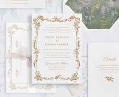 the wedding stationery is laid out on top of an envelope, and there are other items in front of it