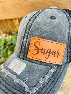 Looking for something different to buy your Sugar?  Gift one of our custom made Sugar hats to the Sugar in your life! You get to choose the color of hat, and then we make the Genuine Leather Sugar patch in house from only the finest leather. These hats are custom to our shop and we make them when you order!  Make sure and browse our selection of men's hats too! Quality and Customer Service are our Top Priority, so please message us with any questions! We are a new shop on Etsy, but we are an established small business in McKinney, TX. Feel free to look at our FB page for a wide range of our work. https://www.facebook.com/restoringwithlove/ Font: Sugar will be in the font shown in the pictures unless you message us prior to ordering and request something different. Hats: Choose the hat colo Customizable Black Snapback Hat, Customizable Black Custom Snapback Hat, Black Hats With Letter Print For Gifts, Black Hats With Letter Print As Gifts, Trucker Hat With Letter Print For Gift, Trucker Hat With Letter Print, Customizable Black Hat As Gift, Gift Letter Print Snapback Hat With Curved Bill, Letter Print Snapback Hat With Curved Bill As Gift