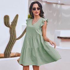 The EMES SHOP dress is detailed with gorgeous ruffle sleeves. Features a v neck line. shift dress silhouette. tiers. and an above knee length. Pair it with a hat and espadrilles for a refreshing summer look.MATERIAL:100% Soft Cotton MEASUREMENTS:Dress Length is 35-37"in Small | Bust & Waist: 37"-39"in Medium | Bust& Waist: 39"-41"in Large | Bust& Waist: 41"-43in V-neck Tiered Dress With Ruffle Hem For Beach, Casual V-neck Tiered Dress For Beach, Green Tiered Ruffle Dress For Beach, Green Summer Tiered Dress, Casual Green Mini Dress With Flutter Sleeves, Casual Solid Color Short Sleeve Tiered Dress, Summer Day Out Tiered Dress, Casual Tiered Dress With Short Sleeves, Spring Tiered Flutter Sleeve Dress With Ruffle Hem