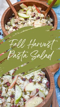 two wooden bowls filled with pasta salad on top of a blue and green table cloth