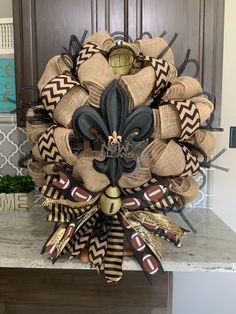 a wreath made out of burlocks and footballs on top of a counter