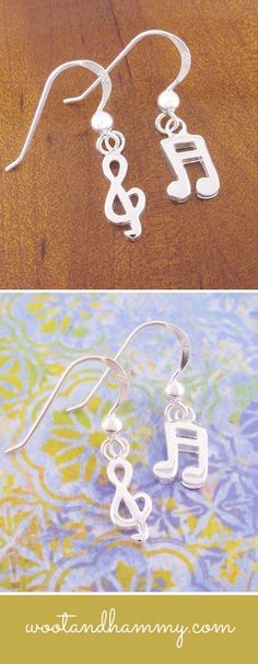 the earrings are made out of metal and have musical notes on them, as well as letters