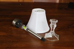 a table with a lamp and some glass items on it