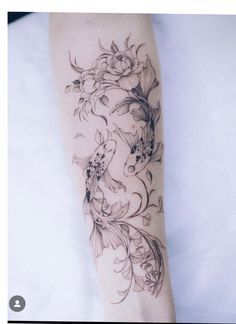 a woman's arm with flowers and leaves tattoo on the left side of her body