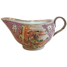 an ornately decorated bowl with handles on the rim and handle is painted in pink, white