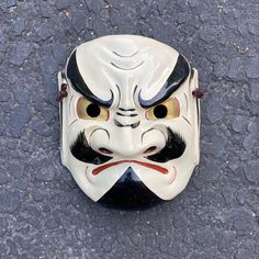 "Japanese Shinto style ritual dance mask. It looks to be made from a type of paper mache, hand painted with a heavy clear coat of finish. Good condition with age appropriate wear with some minor scratches, chips on edges and some paint loss. It looks like it has some age to it, but exact age is uncertain. There's Japanese writing on the back of the mask. Size: approximately 7.75\"H x 6.5\"W x 3\"D" Paper Mache Hand, Ritual Dance, Japanese Writing, Japanese Mask, Up Music, The Mask, Clear Coat, Traditional Japanese, Christmas Carol