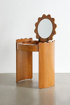 a wooden table with a mirror on it and a stool in the middle that is shaped like a flower