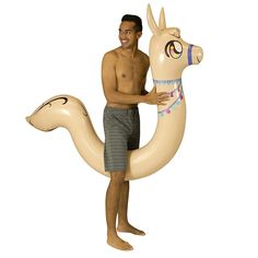 a man is holding an inflatable camel