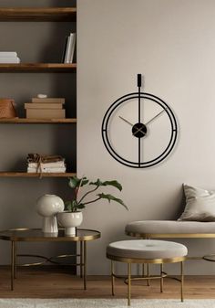 a living room with a couch, coffee table and clock on the wall above it