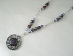 "Hidden Pentacle Necklace This beautiful necklace has purple glass beads, silver plated beads, silver plated chain, pewter silver pendant with purple acrylic setting and a hidden pewter silver pentacle on back. Very discreet. 20\" long. Sterling silver plated lobster clasp." Spiritual Silver Amethyst Beaded Necklaces, Spiritual Silver Amethyst Beaded Necklace, Bohemian Silver Amethyst Beaded Necklace, Nickel Free Purple Metal Necklace, Silver Amethyst Necklace With Polished Beads, Nickel-free Purple Metal Necklace, Spiritual Silver Beaded Necklace With Round Pendant, Gothic Silver Beaded Necklace Perfect For Gifts, Silver Gothic Beaded Necklace As Gift