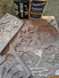 some flowers and leaves are on the table next to gluer, paint and paper