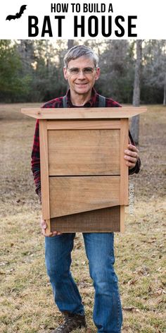 a man holding up a bat house in the middle of a field with text overlay that reads how to build a bat house