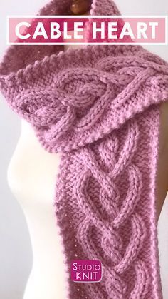 a pink knitted scarf on top of a white mannequin