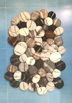 a pile of rocks sitting on top of a blue tiled floor