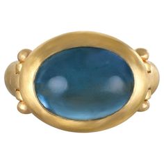 Faye Kim's 22 Karat Gold Aqua Hinged Ring, with its oversize stone, mesmerizing blue hue and half round shank, is beautifully bezel set and matte finished. The ring can be worn for any occasion and is and is sure to be a conversation starter. Aqua 8.5 Carats Bezel Length x Width 20 x 16mm Tapered Shank Width 6mm to 4mm Size 8.5, can be sized Made in the USA Hinged Ring, Power Ring, Bezel Ring, Jewelry Fashion Trends, Blue Hues, Pink Tourmaline, Bezel Setting, Hinges, Beautiful Rings