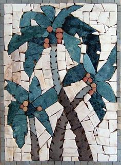 a mosaic tile wall hanging with a palm tree on it's side and blue leaves in the middle