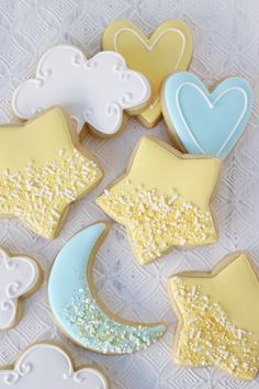 decorated cookies are arranged in the shape of stars, moon and clouds