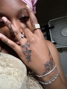 a woman with tattoos on her arm and hand