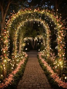 an archway decorated with flowers and lit candles