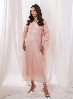 step into elegance with our stunning powder pink ensemble paired with a delicately crafted organza dupatta in the same ethereal hue. The shirt features intricate self-print with white cutwork on hem, adding a touch of timeless charm and intricate detailing to the soft pastel canvas. Elevate your style effortlessly with this ensemble, perfect for both daytime soirees and evening affairs. Shirt: Self JacquardPants: Raw SilkDupatta: Organza Elegant Pink Lace Work Sets, Elegant Summer Kurta With Naqshi, Summer Wedding Pink Lawn Suit, Elegant Naqshi Kurta For Spring, Elegant Naqshi Lawn Suit For Spring, Elegant Naqshi Dupatta For Spring, Elegant Cutwork Kurta For Spring, Pink Cutwork Sets For Eid, Elegant Spring Lawn Suit With Naqshi Detail