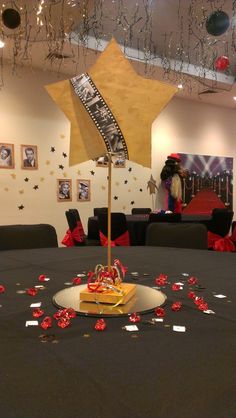 the table is set up for a party with confetti and streamers on it