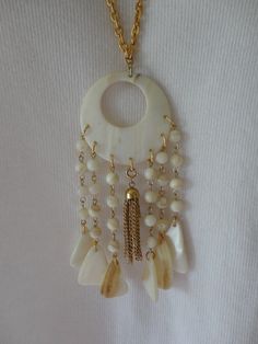 "As shown. This is quite fabulous! Chunky luminous Mother of Pearl throughout, including the beads. Gold tone chain necklace. Chain tassel dangle is attached with a spring ring clasp in case you might want to remove it and put something else there. Necklace has no clasp, it slips over head. The entire pendant drop measures 5\" + chain length which is 28\". In very good condition. Will come in a gift box." Lariat Necklace, Necklace Chain, Estate Jewelry, Spring Rings, Chain Lengths, Chain Length, Mother Of Pearl, Tassels, Statement Necklace