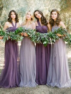 the bridesmaids are wearing purple dresses and holding greenery in their hands together