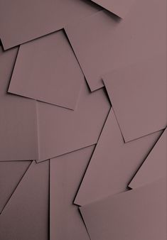 many pieces of paper are stacked together on top of each other in an abstract pattern