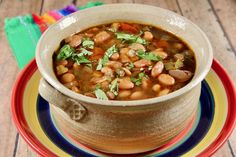 a white bowl filled with beans on top of a plate