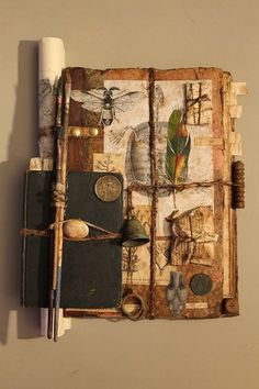 an old book with many different things on it, including a pen and paper roll