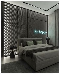 a bed sitting in a bedroom next to a wall with the words be happy on it