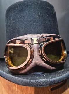 Dress up like a character from a science fiction novel with these beautiful Steampunk Goggles! An extremely original accessory, perfect to combine with a hat and absolutely necessary for every successful party. The lenses are dark; you can replace them by unscrewing the front part of the frame. The width is adjustable via the rear elastic. Made with plastic material, these glasses are a fun and economical way to join the Steampunk world! Adjustable Retro Costume Accessories For Costume Party, Steampunk Brimmed Costume Accessories For Party, Steampunk Brimmed Costume Accessories For Costume Party, Adjustable Brimmed Costume Accessories For Cosplay, Adjustable Brown Halloween Costume Accessories, Vintage Adjustable Costume Accessories For Costume Party, Vintage Brimmed Costume Accessories, Adjustable Brimmed Themed Costume Accessories, Vintage Adjustable Costume Accessories For Festivals