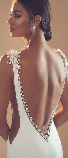 the back of a woman wearing a white dress