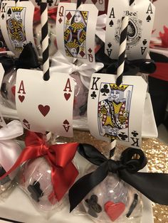 playing cards are wrapped in cellophane and tied with black ribbon, along with candy candies