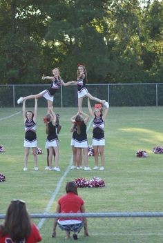 the cheerleaders are doing tricks on the field