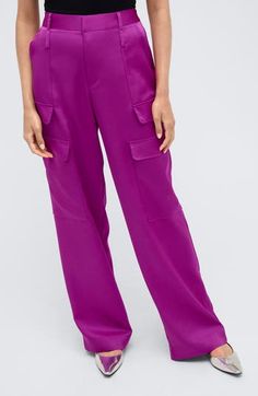 Cargo pants carry off a glow up with a satin fabrication that renders the look ready to work the party circuit. 31" inseam; 22" leg opening Zip fly with hook-and-bar closure Front slant pockets; cargo flap-patch pockets; back welt pocket 100% polyester Hand wash, tumble dry Imported Spring Satin Straight Leg Pants, Purple Straight Leg Pants With Cargo Pockets, Wide Leg Satin Pants With Pockets, Satin Straight Pants With Pockets, Trendy Purple Straight Leg Cargo Pants, Chic Satin Bottoms With Pockets, Party Wide-leg Cargo Pants With Pockets, Trendy Party Cargo Pants With Pockets, Trendy Cargo Pants With Pockets For Party