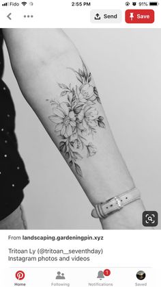 a woman's arm with flowers on it and an instagramr below the wrist