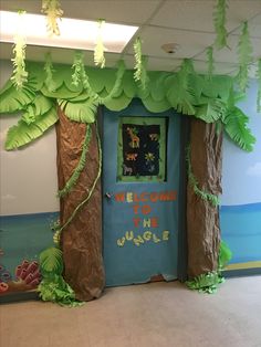 a welcome to the jungle classroom door decorated with paper mache and fake palm trees