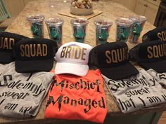 hats and cups are arranged on a counter top with the names of bride and groom