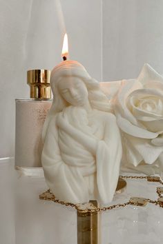 a candle that is next to some flowers