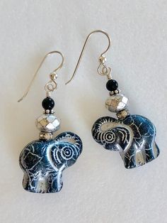 "Stunning Sterling silver black Czech glass elephant earrings featuring premium Czech glass jet black elephants with metallic silver wash accented by genuine black onyx and Czech silver mercury beads. Beautiful 3D elephants are 20 x 21 mm x 9 mm thick yet lightweight. New silver mercury Czech glass beads are faceted and sparkle with silver metallic Picasso finish. Little gunmetal silver rhinestone rondelles have lovely AB or Aurora Borealis finish. On top is a polished genuine 4 mm black onyx ge Black Bohemian Hypoallergenic Jewelry, Black Hypoallergenic Bohemian Jewelry, Unique Black Hypoallergenic Jewelry, Black Elephant, Glass Bangles, Elephant Earrings, Adjustable Bangle Bracelet, Sea Glass Earrings, Black Earrings