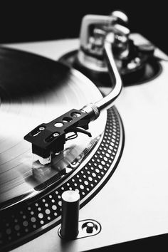 a turntable with a record player attached to it's side, in black and white