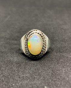 Natural Ethiopian Opal Silver Ring, 925 Solid Sterling Silver Ring, Cabochon Stone Ring, Bridal Jewelry, Wedding Rings, Vintage Opal Ring, Christmas gifts, Anniversary Gifts, Gift for Her. Description Gemstone: Opal Gemstone Color : Multi Color Gemstone Shape: Oval Gemstone : Size 8 x 10 mm Ring Weight : 3.0 mm Metal: Sterling Silver Material: 925 Sterling silver, Polished, Gemstone. Stone Creation: Natural Metal Purity: 925 parts per 1000 Country/Region of Manufacture: India Brand : Brand: Tanu Shree Jewellers Setting Type: Bezel Available in 925 sterling silver. This is Solid Handmade Sterling Silver Ring with Natural Gemstone. We are using Pure 925 (Stamped) Sterling Silver with Gemstone Jewelry, our jewelry designs are Handmade and some design are casting. We do handmade and casting wo Opal Silver Ring, Opal Ring Vintage, Bridal Jewelry Vintage, Handmade Sterling Silver Rings, Precious Opal, Types Of Opals, Cabochon Ring, Types Of Gemstones, Opal Crystal