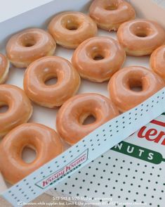 an open box of krispy kreme glazed donuts