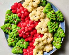 a plate full of cookies decorated with green and red frosting