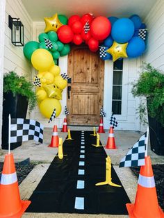 an entrance decorated with balloons and checkered flags