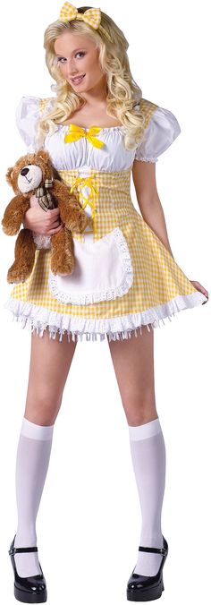 a woman in a yellow and white dress holding a teddy bear