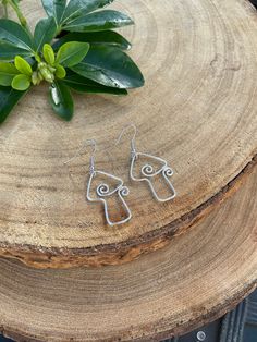 Elevate your style with our wire-wrapped mushroom earrings--each one a tiny masterpiece of whimsy and craftsmanship. Embrace the enchanting charm of nature, effortlessly adorning your ears with a touch of woodland magic.  Wrapped in silver plated wire or sterling silver 💫 Silver plated earrings are adorned with surgical steel hypoallergenic hooks 🌸  Sterling silver earrings are adorned with sterling silver hooks 🌸   Check out my etsy for other unique treasures! ✨ 🔮 -------------------- Follo Adjustable Wire Wrapped Whimsical Earrings, Whimsical Adjustable Wire Wrapped Earrings, Whimsical Wire Wrapped Drop Earrings, Whimsical Wire Wrapped Metal Earrings, Bohemian Dangle Earrings With Mushroom Design, Silver Wire Wrapped Nature-inspired Earrings, Nature-inspired Silver Wire Wrapped Earrings, Nature-inspired Wire Wrapped Earrings For Gifts, Nature-inspired Sterling Silver Wire Wrapped Earrings